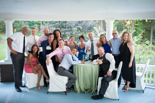 wedding guests surrounding table on veranda