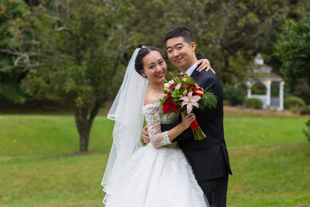 wedding couple embracing and smiling for camera