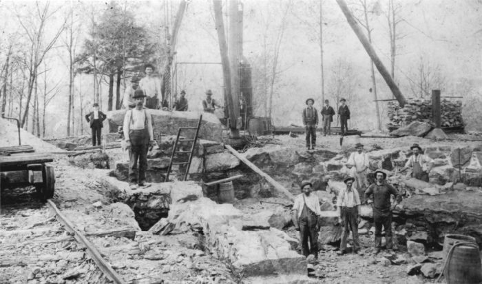 black and white photo of "Mad Hatters" working to mine limestone for the Hearthstone castle