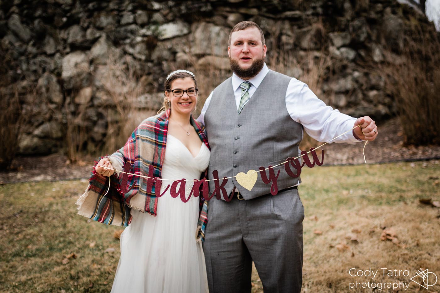 wedding-couple-outside-in-front-of-mansion-with-thank-you-banner