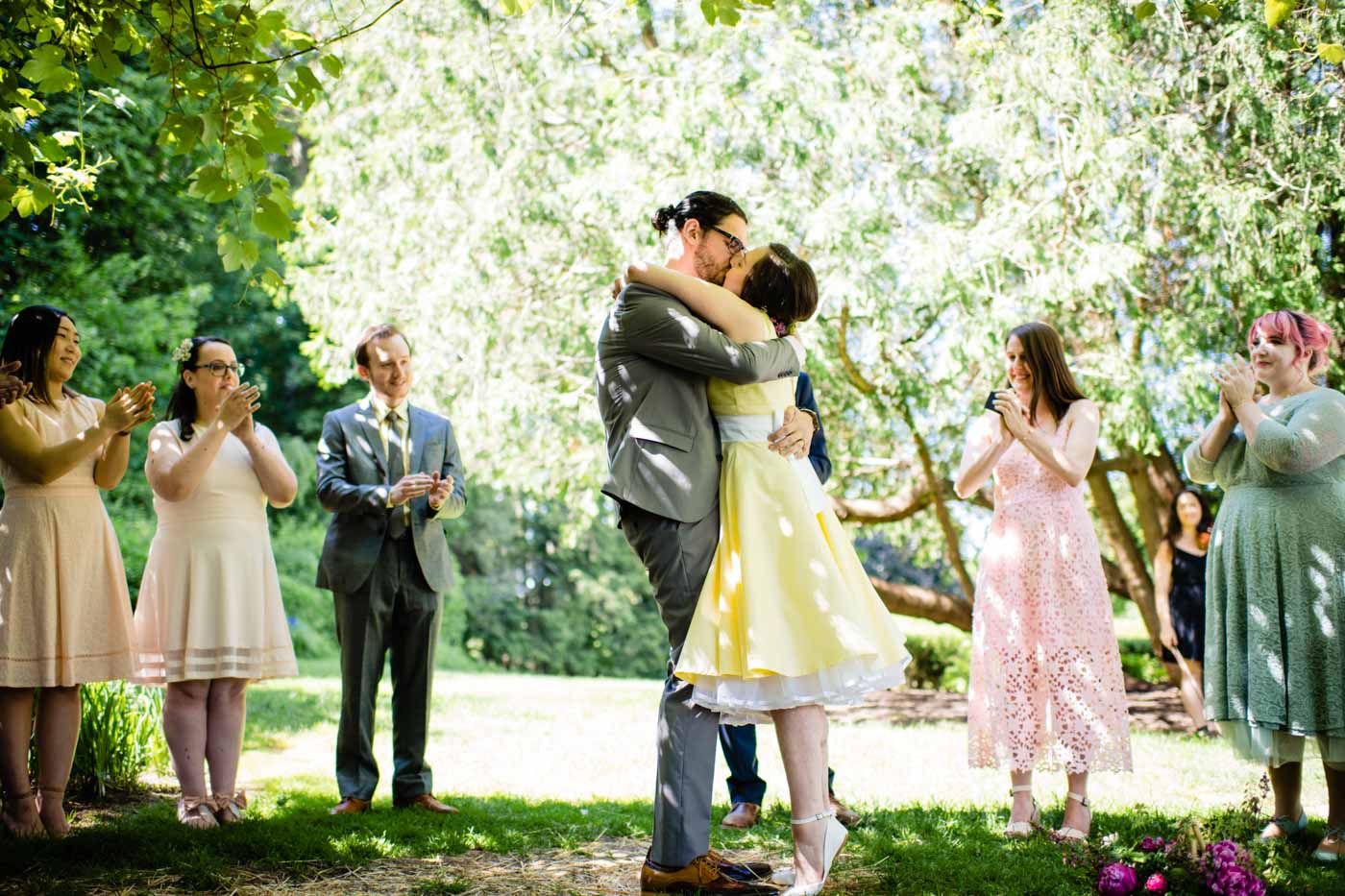 bride-groom-kissing-after-ceremony-in-garden