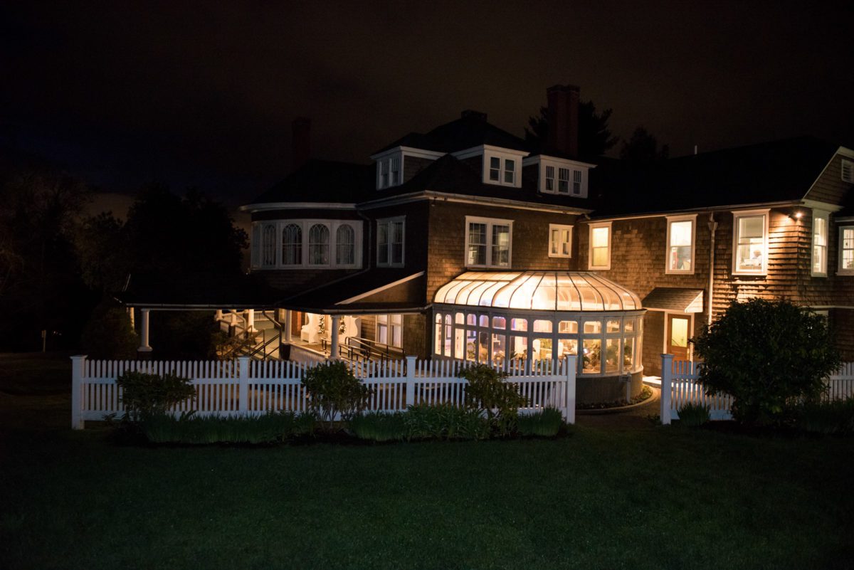 back of mansion lit up at night