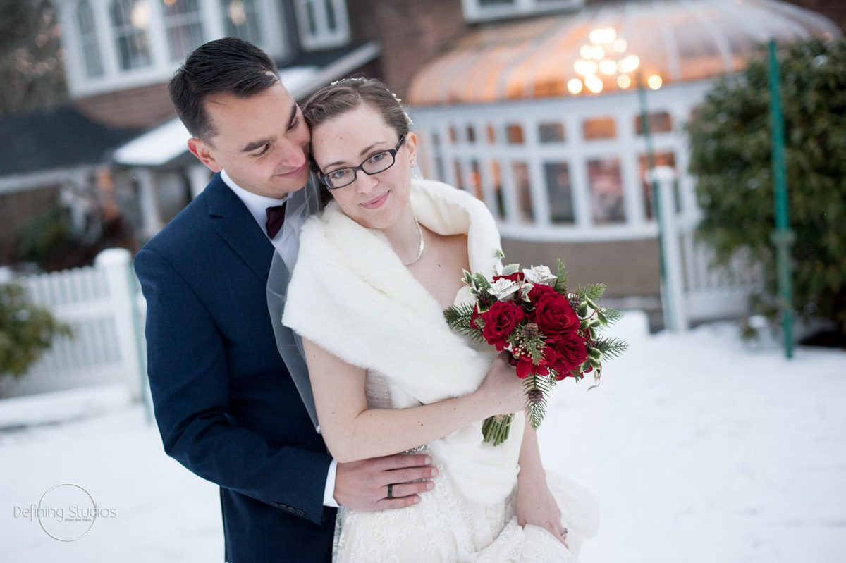 bride-groom-outside-infront-of-conservatory-for-winter-wedding