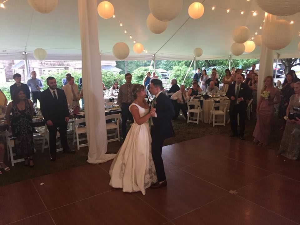 couple dancing under tent