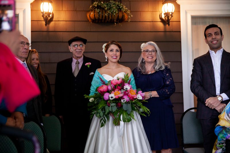 cuban-flair-wedding-bride-walking-with-her-mom-and-dad-down-the-aisle