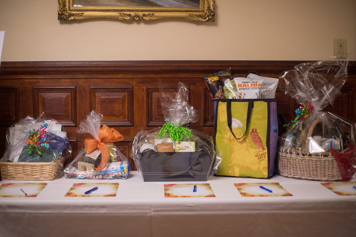 harvest dinner silent auction table with baskets of prizes