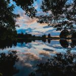 pond at twilight reflecting clouds