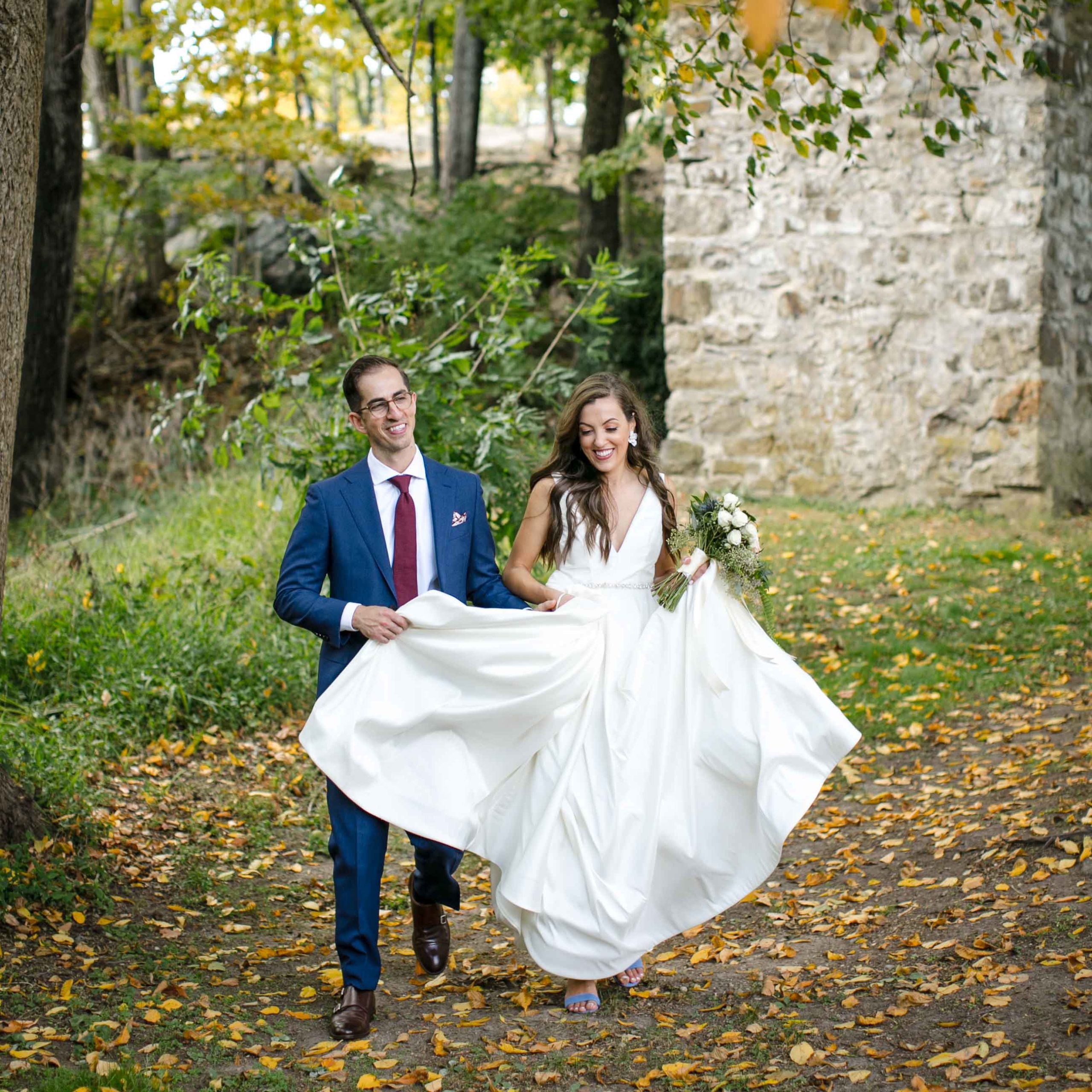 bride and groom walking on leaf strewn lawn